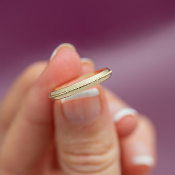 model holding yellow gold band