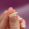 model holding yellow gold band