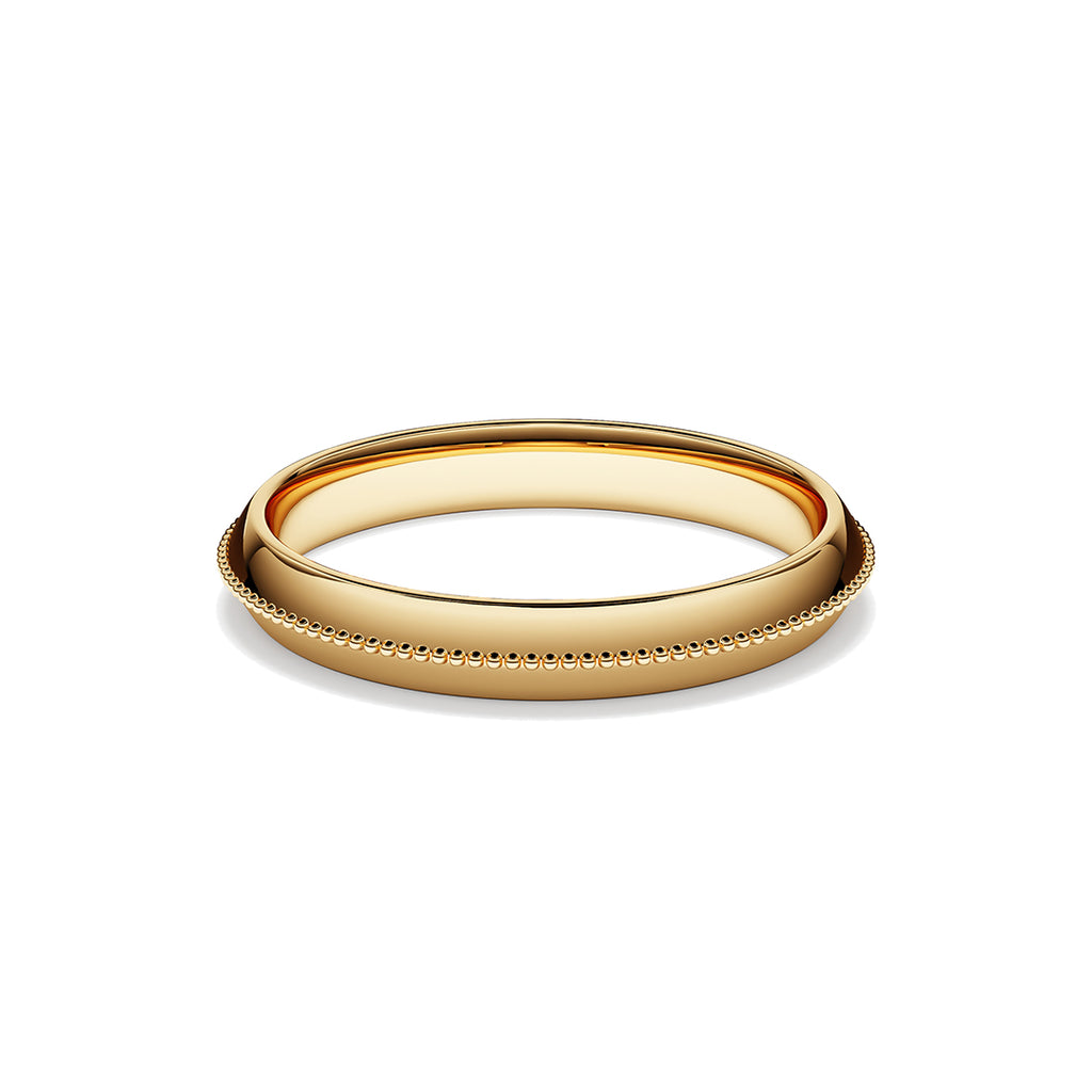 Ring with mill-grained detailing on a pitched yellow gold band