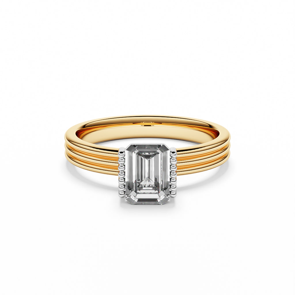 Ring with a emerald cut diamond on a yellow gold band.
